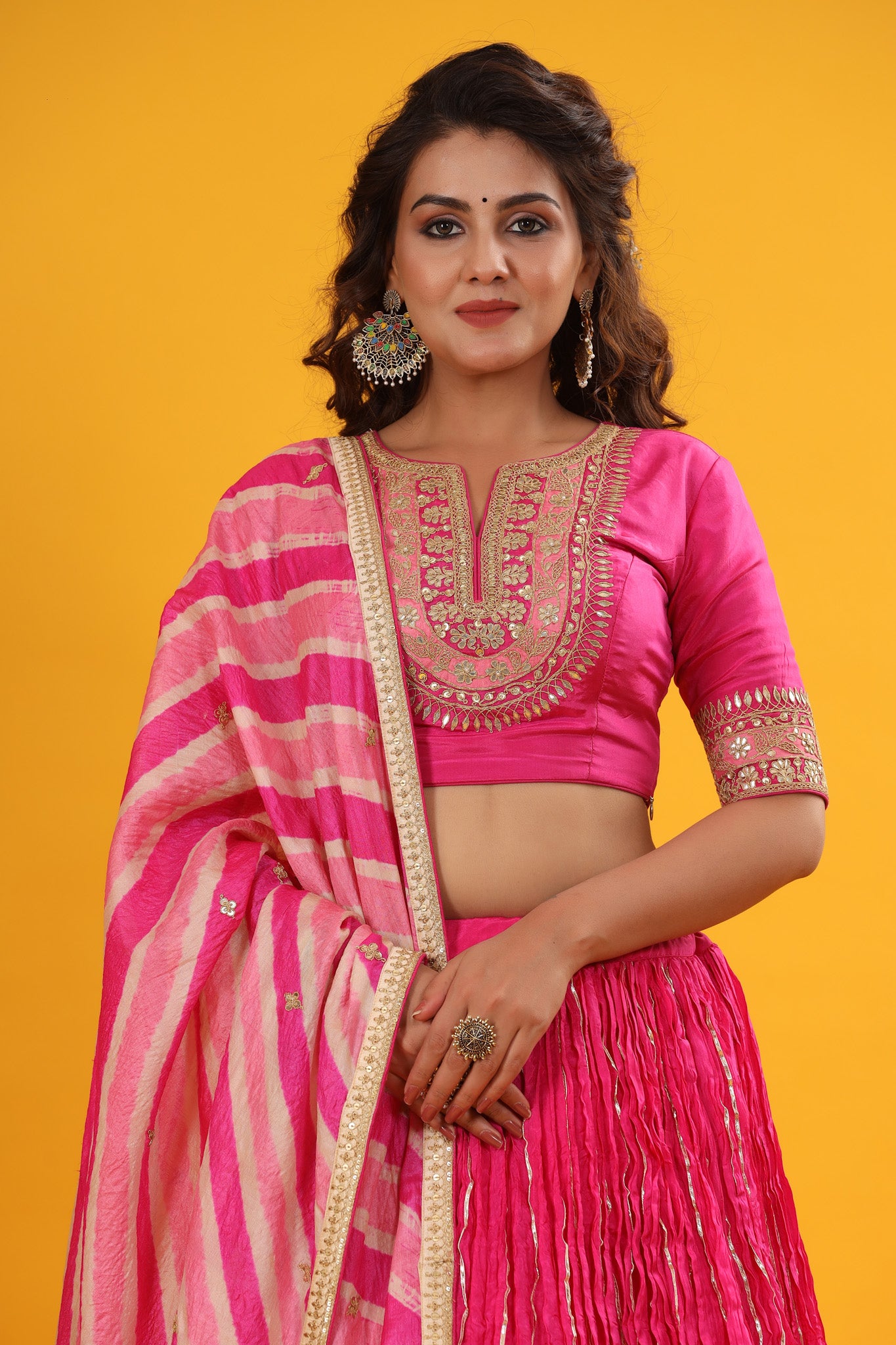 Shop a Pink gota patti embroidered set featuring silk dupatta set. It comes with a beautiful striped multicolor embroidered dupatta, pink blouse with hook closure and tie up at back. Pair it with beautiful jewelry to enhance your look. Shop online from Pure Elegance.