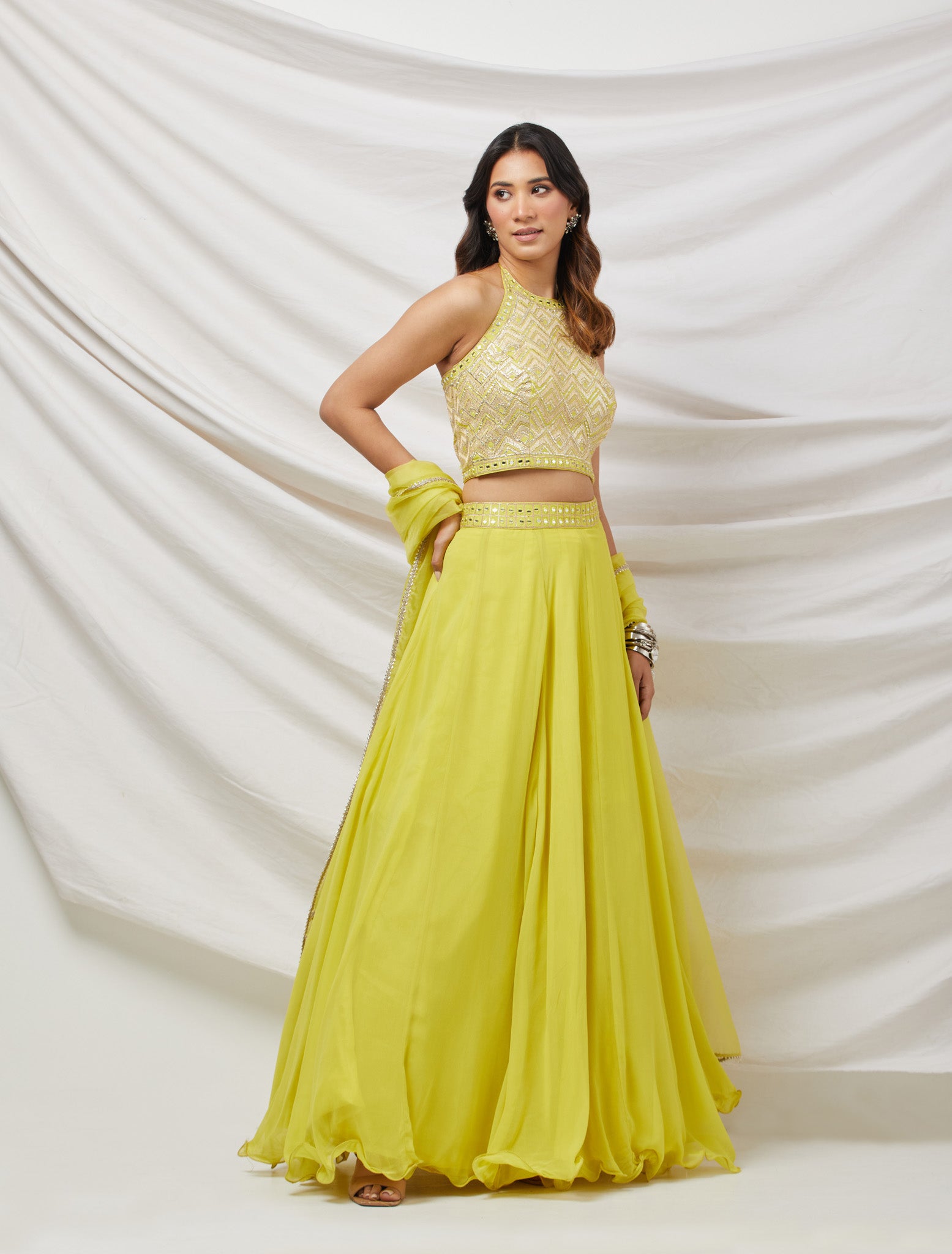 Shop a green lime gotta patti and mirror work lehenga with embroidered blouse & dupatta. Dazzle on weddings and special occasions with exquisite Indian designer dresses, sharara suits, Anarkali suits, bridal lehengas, and sharara suits from Pure Elegance Indian clothing store in the USA. Shop online from Pure Elegance.