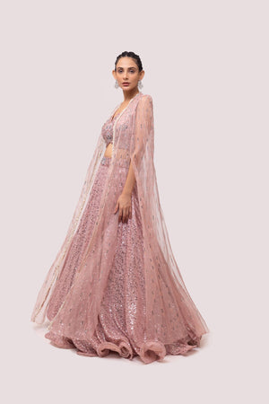 Shop this light pink lehenga with intricate pearls, cut dana, and sequence work. Dazzle on weddings and special occasions with exquisite Indian designer dresses, sharara suits, Anarkali suits, bridal lehengas, and sharara suits from Pure Elegance Indian clothing store in the USA. Shop online from Pure Elegance.
