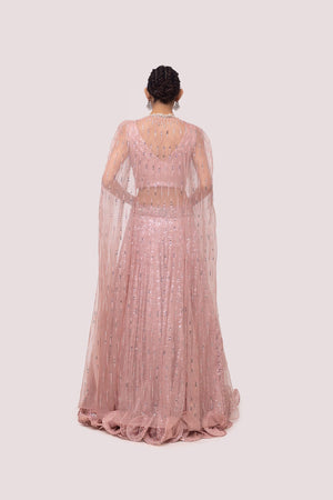 Shop this light pink lehenga with intricate pearls, cut dana, and sequence work. Dazzle on weddings and special occasions with exquisite Indian designer dresses, sharara suits, Anarkali suits, bridal lehengas, and sharara suits from Pure Elegance Indian clothing store in the USA. Shop online from Pure Elegance.