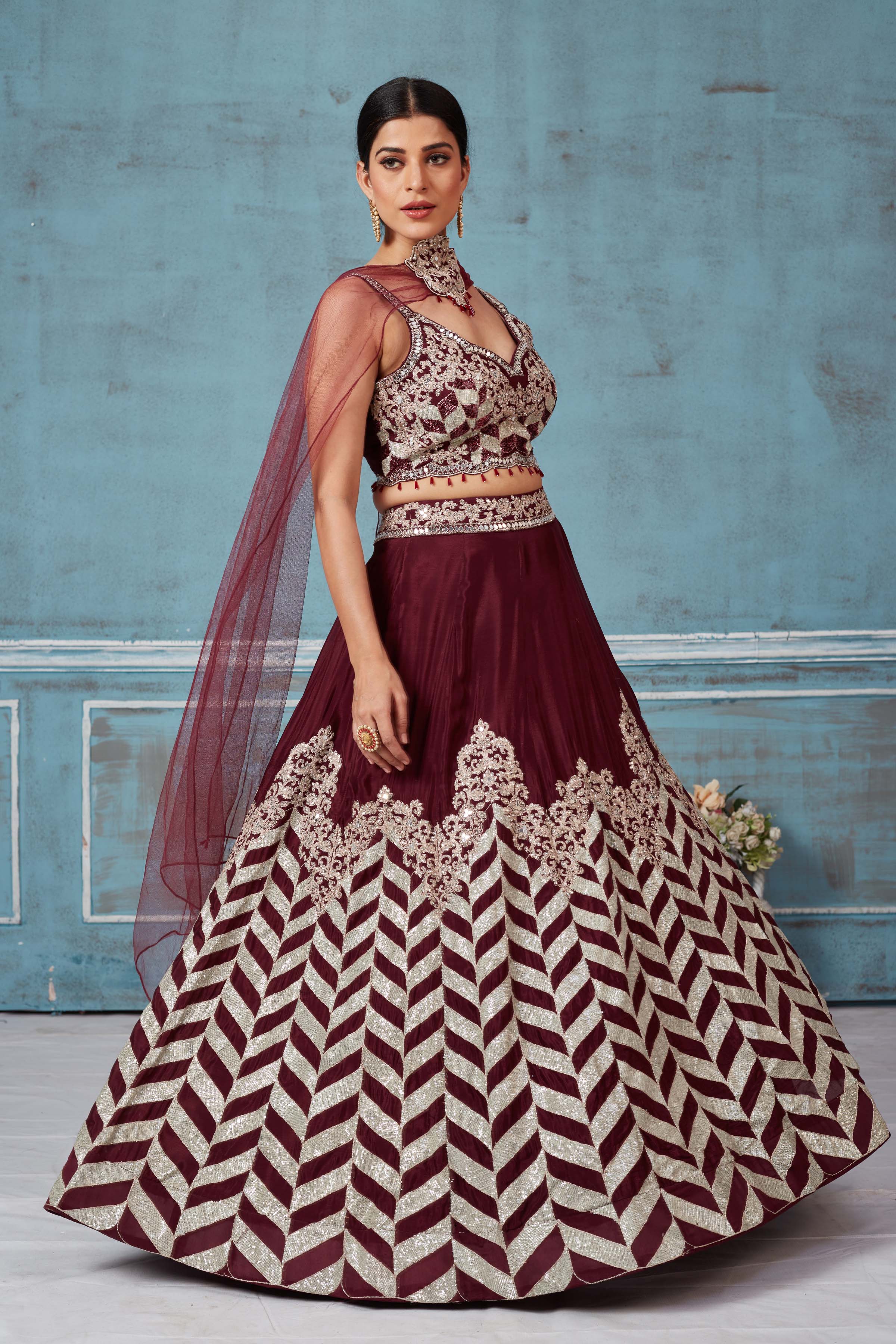 Buy maroon embroidered silk designer lehenga online in USA with dupatta. Look royal on special occasions in exquisite designer lehengas, pure silk sarees, handloom sarees, Bollywood sarees, Anarkali suits, Banarasi sarees, organza sarees from Pure Elegance Indian saree store in USA.-side