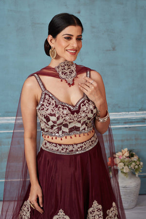 Buy maroon embroidered silk designer lehenga online in USA with dupatta. Look royal on special occasions in exquisite designer lehengas, pure silk sarees, handloom sarees, Bollywood sarees, Anarkali suits, Banarasi sarees, organza sarees from Pure Elegance Indian saree store in USA.-closeup