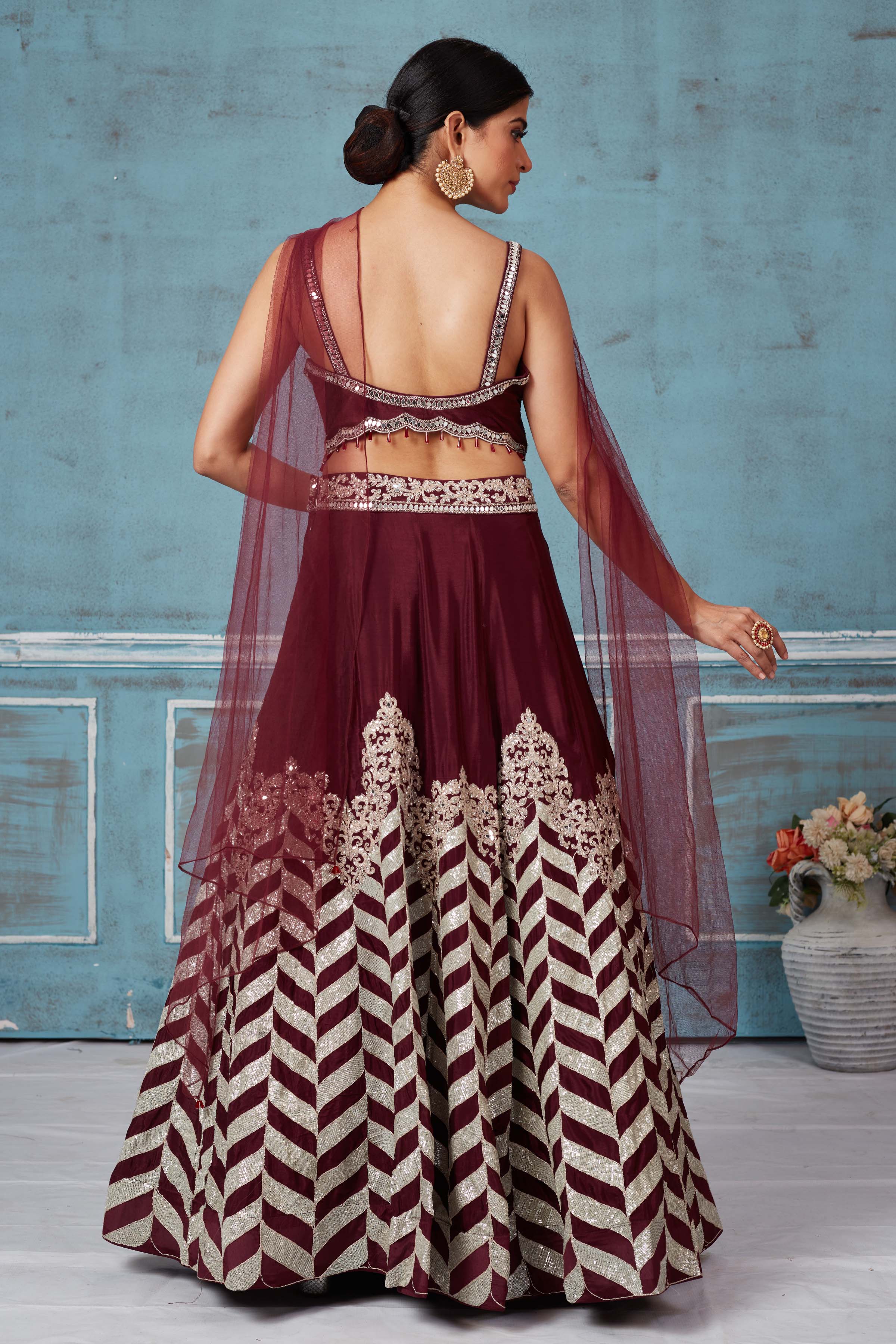 Buy maroon embroidered silk designer lehenga online in USA with dupatta. Look royal on special occasions in exquisite designer lehengas, pure silk sarees, handloom sarees, Bollywood sarees, Anarkali suits, Banarasi sarees, organza sarees from Pure Elegance Indian saree store in USA.-back