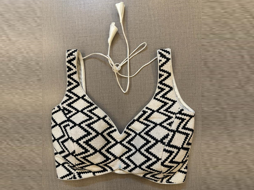 Buy cream and black geometric pattern sleeveless saree blouse online in USA. Elevate your saree style with exquisite readymade sari blouses, embroidered saree blouses, Banarasi sari blouse, designer saree blouse, choli-cut blouses, corset blouses from Pure Elegance Indian fashion store in USA.-full view
