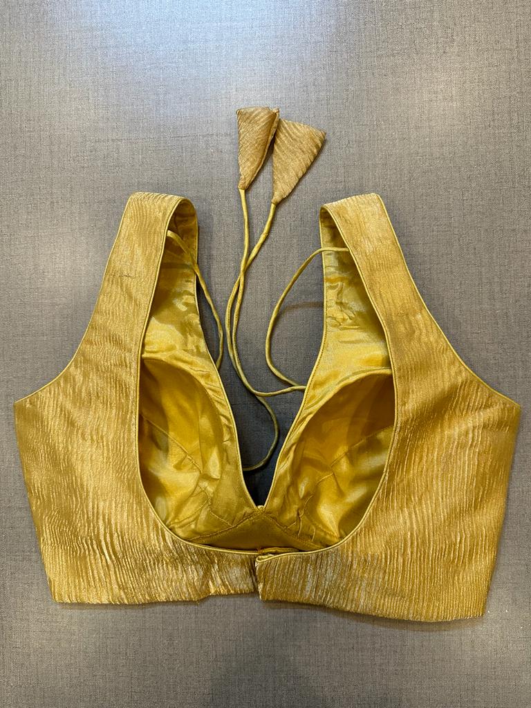 Buy golden tissue sleeveless padded saree blouse online in USA. Elevate your saree style with exquisite readymade sari blouses, embroidered saree blouses, Banarasi sari blouse, designer saree blouse, choli-cut blouses, corset blouses from Pure Elegance Indian fashion store in USA.-back