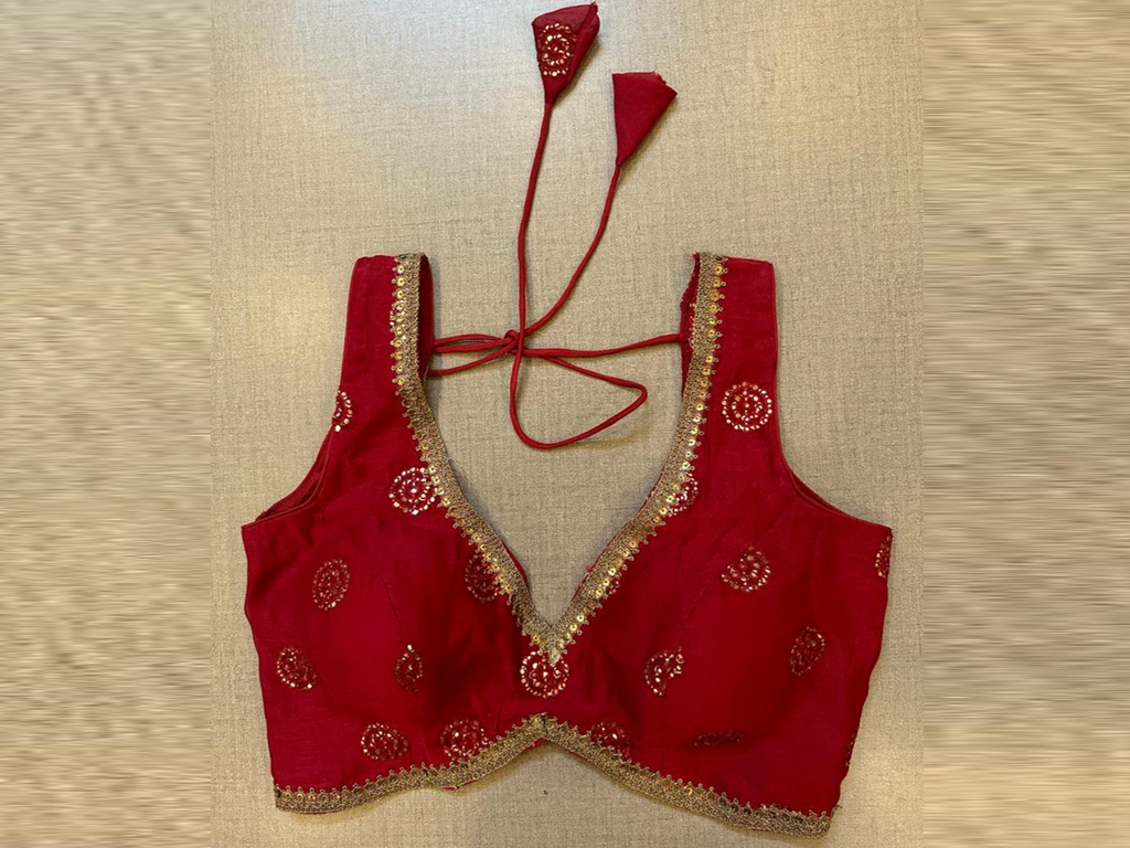 Shop stunning red embroidered sleeveless saree blouse online in USA. Elevate your saree style with exquisite readymade sari blouses, embroidered saree blouses, Banarasi sari blouse, designer saree blouse, choli-cut blouses, corset blouses from Pure Elegance Indian fashion store in USA.-full view