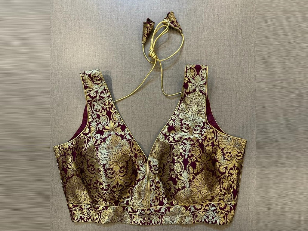 Shop wine color Banarasi sleeveless saree blouse online in USA. Elevate your saree style with exquisite readymade sari blouses, embroidered saree blouses, Banarasi sari blouse, designer saree blouse, choli-cut blouses, corset blouses from Pure Elegance Indian fashion store in USA.-full view