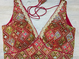 Buy maroon multicolor sleeveless blouse with thread and mirror embroidery. Make a fashion statement on festive occasions and weddings with designer blouses, designer sarees, designer suits, Indian dresses, designer gowns, sharara suits, and embroidered sarees from Pure Elegance Indian fashion store in the USA.
