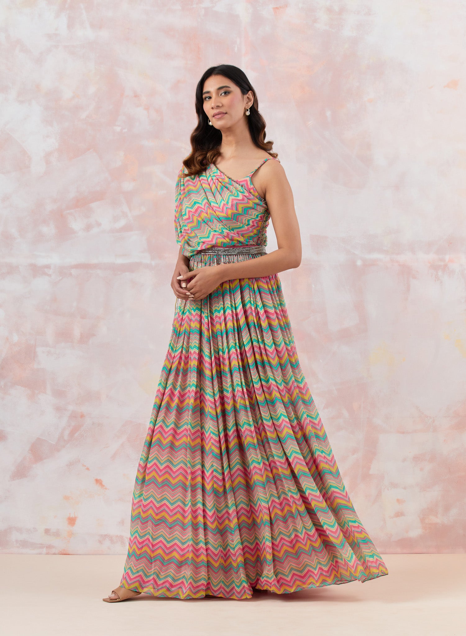 Buy a Pink stylish gown dress crafted in the softest Chinon fabric. the draped neckline brings in glamour. Dazzle on weddings and special occasions with exquisite Indian designer dresses, sharara suits, Anarkali suits, and wedding lehengas from Pure Elegance Indian fashion store in the USA.