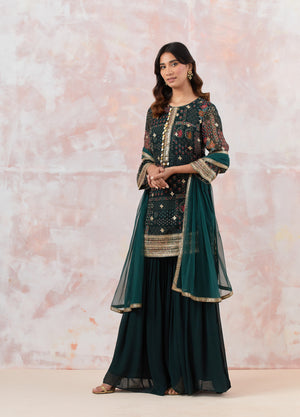 Buy Bottle green sharara set featuring Kurta with foil work, shells, and coin detailing, also plain sharara  It is best for occasions & parties. Dazzle on weddings and special occasions with exquisite Indian designer dresses, sharara suits, Anarkali suits, and wedding lehengas from Pure Elegance Indian fashion store in the USA.