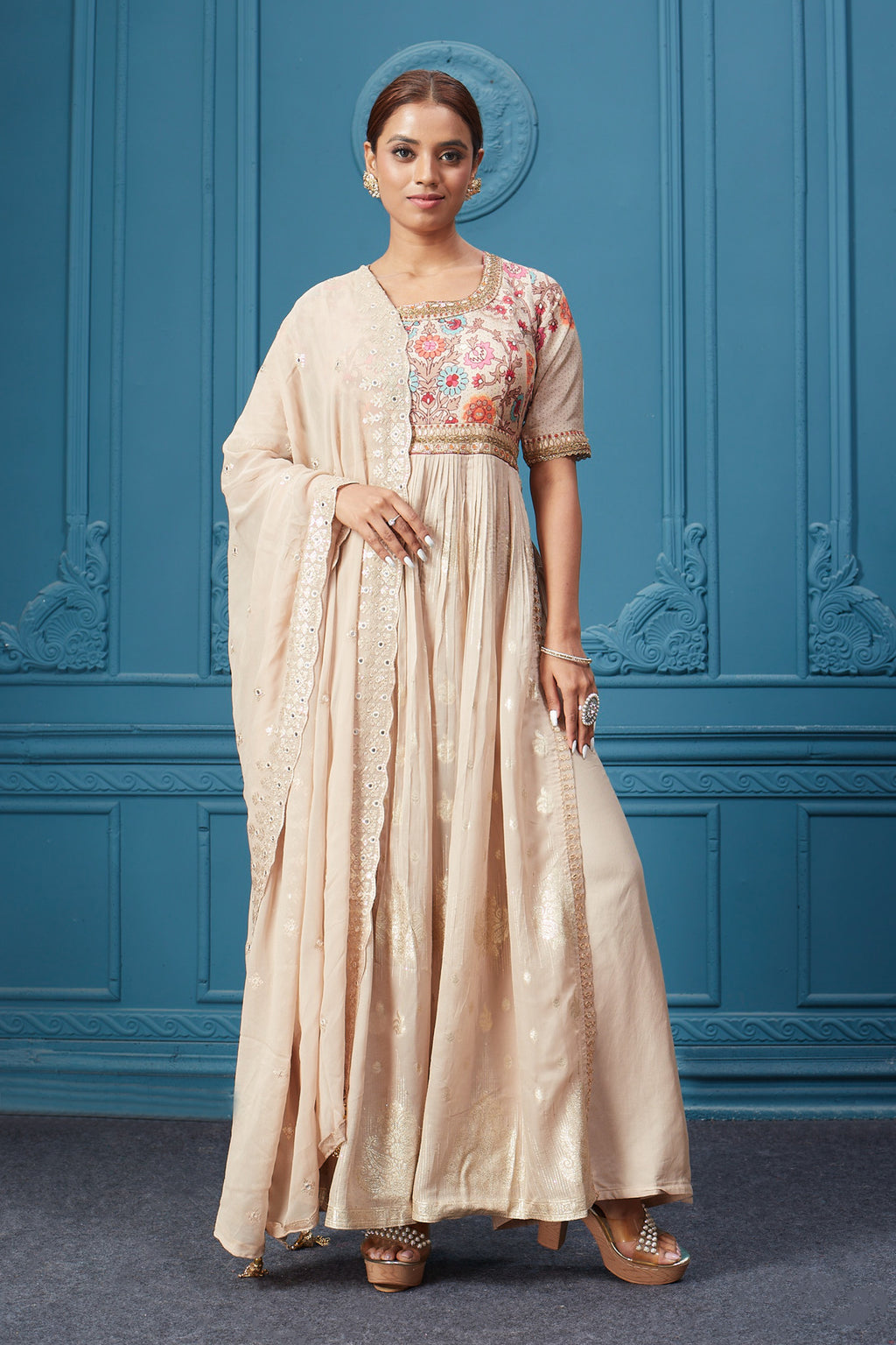 Shop a beige naira cut suit set with mirror work and embroidered kurta, plazzo, 3/4th sleeves, and beautiful mirror work embroidered dupatta. Dazzle on special occasions with exquisite Indian designer dresses, sharara suits, Anarkali suits, bridal lehengas, and sharara suits from Pure Elegance Indian clothing store in the USA. Shop online from Pure Elegance.