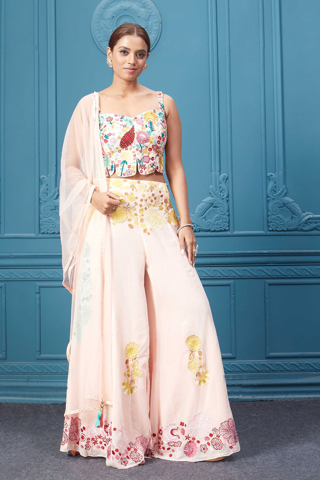 Shop light pink embroidered sleeveless crop kurta, stylish plazzo, and beautiful dupatta. Dazzle on special occasions with exquisite Indian designer dresses, sharara suits, Anarkali suits, bridal lehengas, and sharara suits from Pure Elegance Indian clothing store in the USA. Shop online from Pure Elegance.