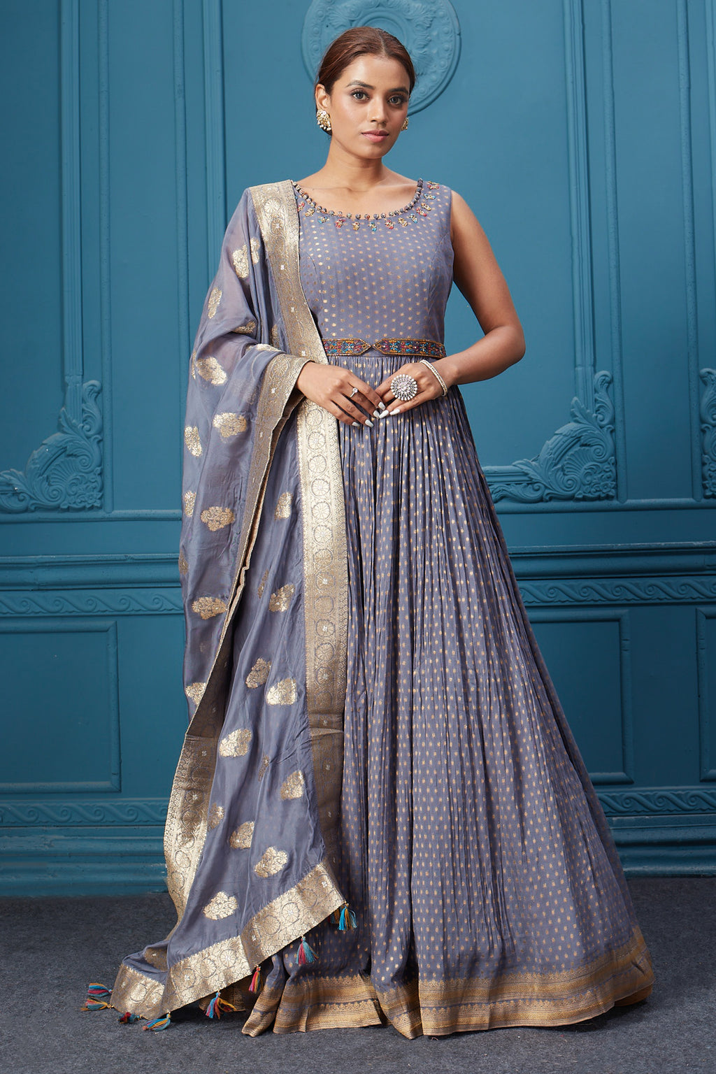 Buy a grey embroidered sleeveless Anarkali kurta featuring embroidery, and a grey dupatta with tassels. Dazzle on special occasions with exquisite Indian designer dresses, sharara suits, Anarkali suits, bridal lehengas, and sharara suits from Pure Elegance Indian clothing store in the USA. Shop online from Pure Elegance.