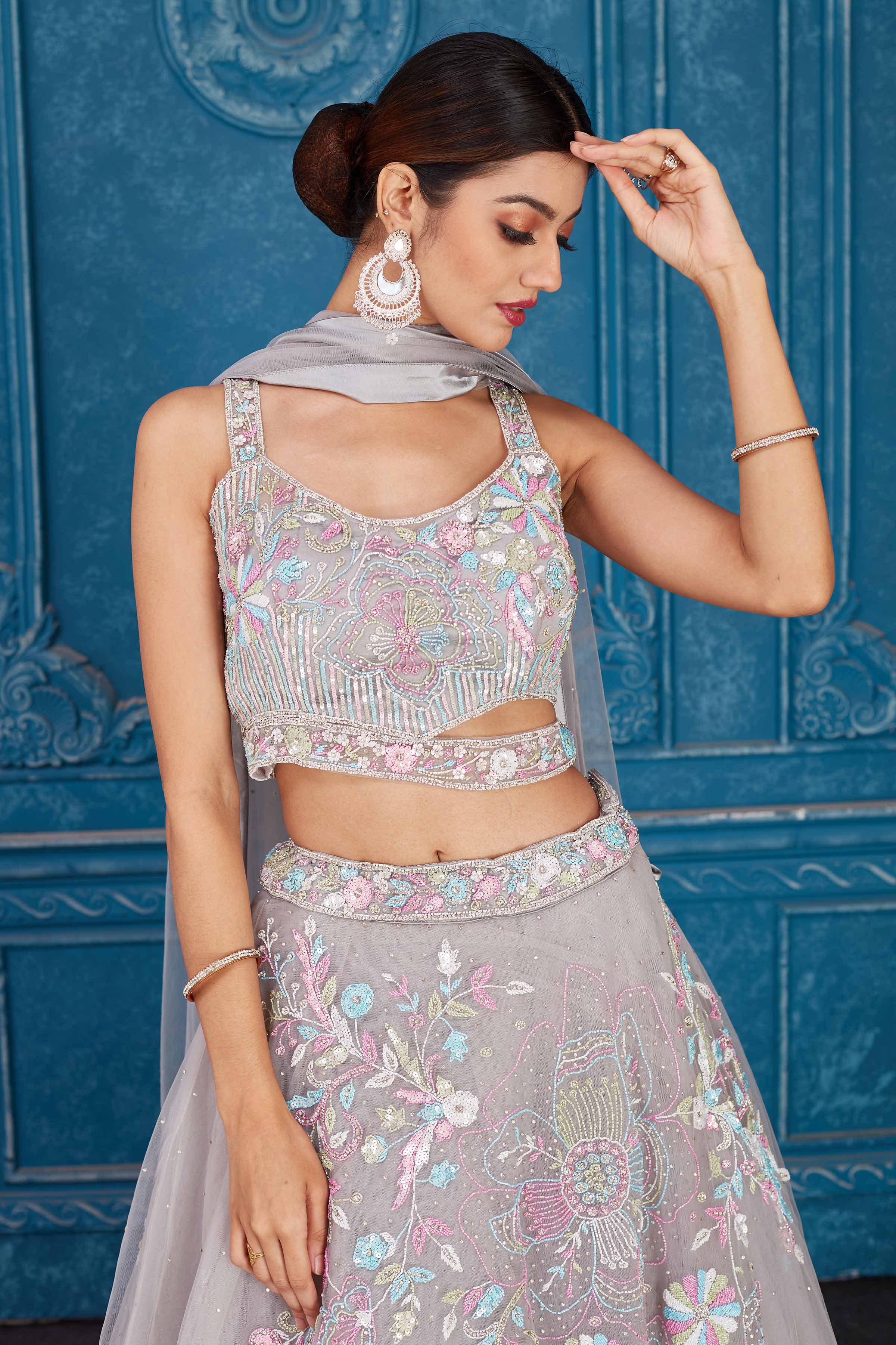 Shop light grey embroidered net lehenga online in USA with dupatta. Slay in style at wedding festivities in this beautiful designer lehengas. hand embroidered lehengas, Bollywood lehenga, Anarkali suits, sharara suits from Pure Elegance Indian saree store in USA. -closeup