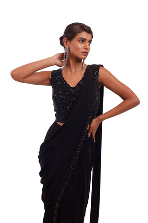 Buy beautiful black crepe draped saree online in USA with sequin blouse. Look your best at parties and weddings in beautiful designer sarees, embroidered sarees, handwoven sarees, silk sarees, organza saris from Pure Elegance Indian saree store in USA.-closeup