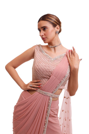 Buy stunning light pink draped lycra saree online in USA with embellished blouse. Look your best at parties and weddings in beautiful designer sarees, embroidered sarees, handwoven sarees, silk sarees, organza saris from Pure Elegance Indian saree store in USA.-closeup
