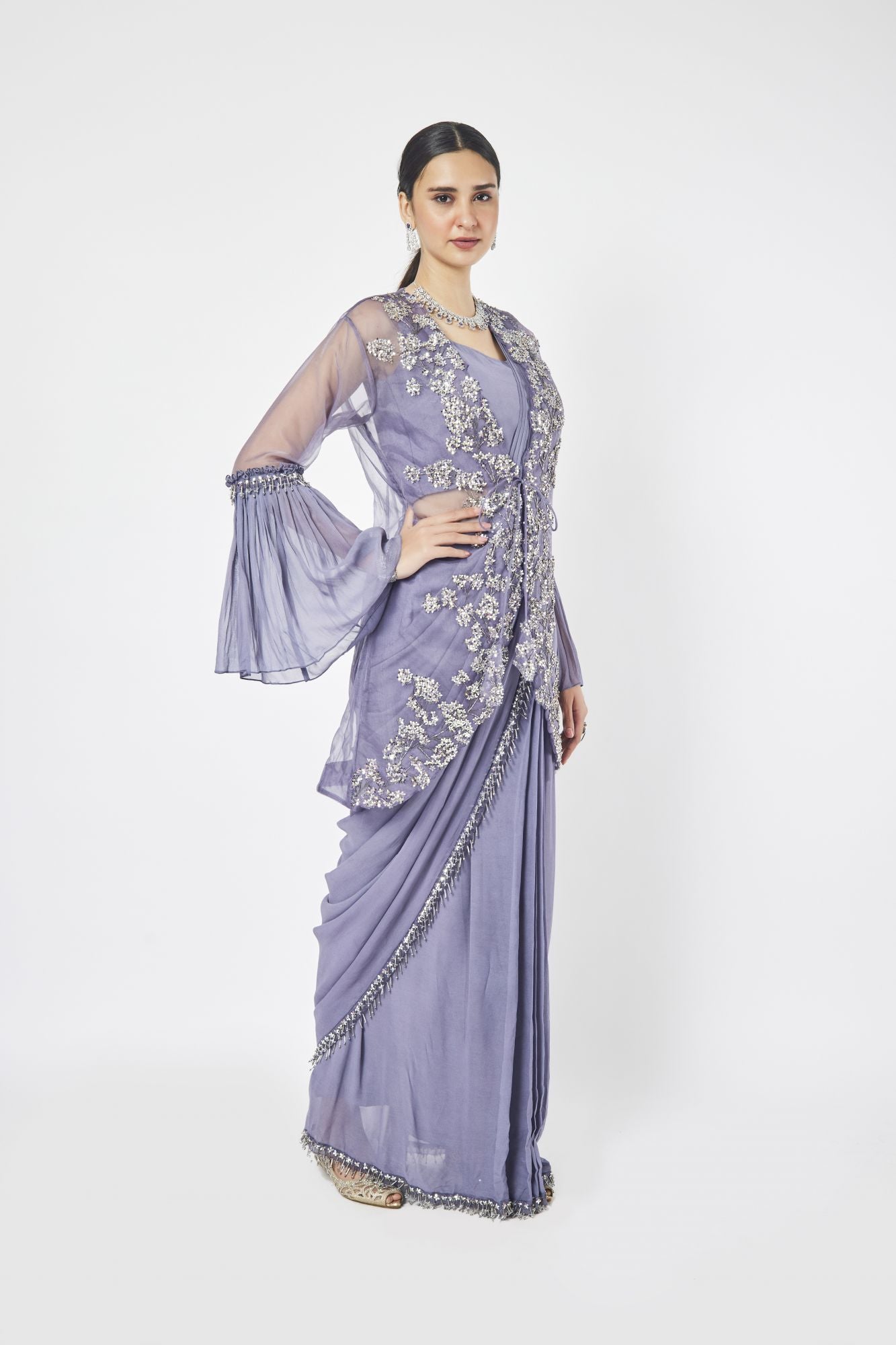 Shop mauve drape saree with ruffle sleeves Make a fashion statement on festive occasions and weddings with designer sarees, designer suits, Indian dresses, Anarkali suits, palazzo suits, designer gowns, sharara suits, and embroidered sarees from Pure Elegance Indian fashion store in the USA.