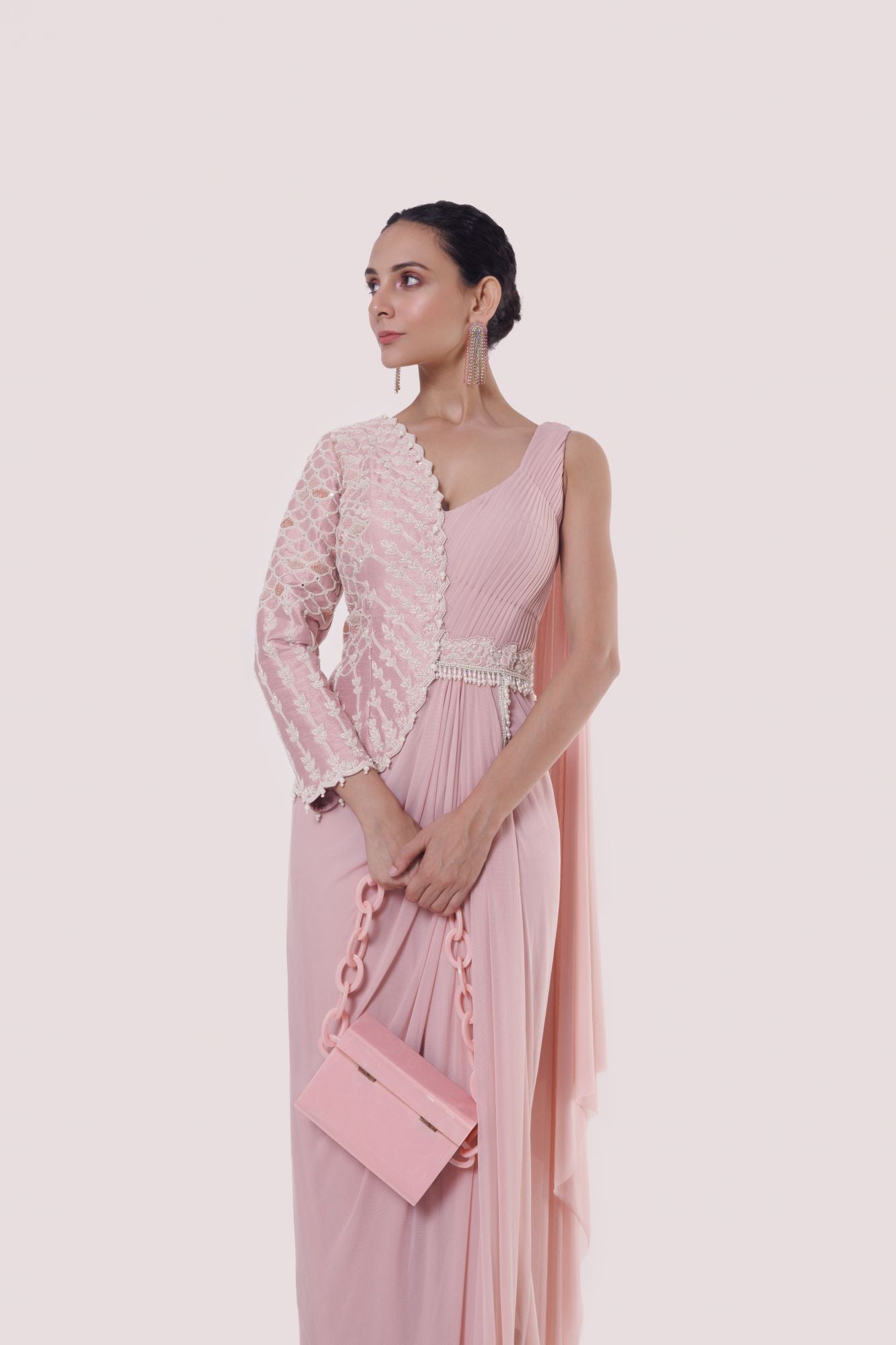 Shop a light pink drape saree set with a faux jacket. Make a fashion statement on festive occasions and weddings with designer sarees, designer suits, Indian dresses, Anarkali suits, palazzo suits, designer gowns, sharara suits, and embroidered sarees from Pure Elegance Indian fashion store in the USA.