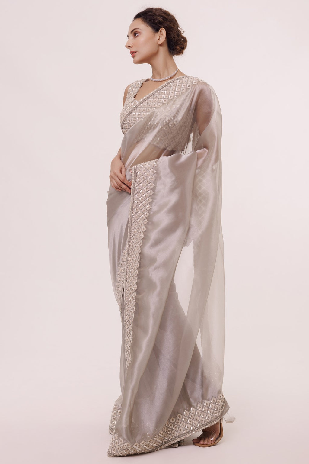 Buy beautiful metallic silver organza saree online in USA with embroidered border and saree blouse. Look your best at parties and weddings in exquisite designer sarees, embroidered sarees, handloom sarees, silk sarees, organza saris from Pure Elegance Indian saree store in USA.-full view