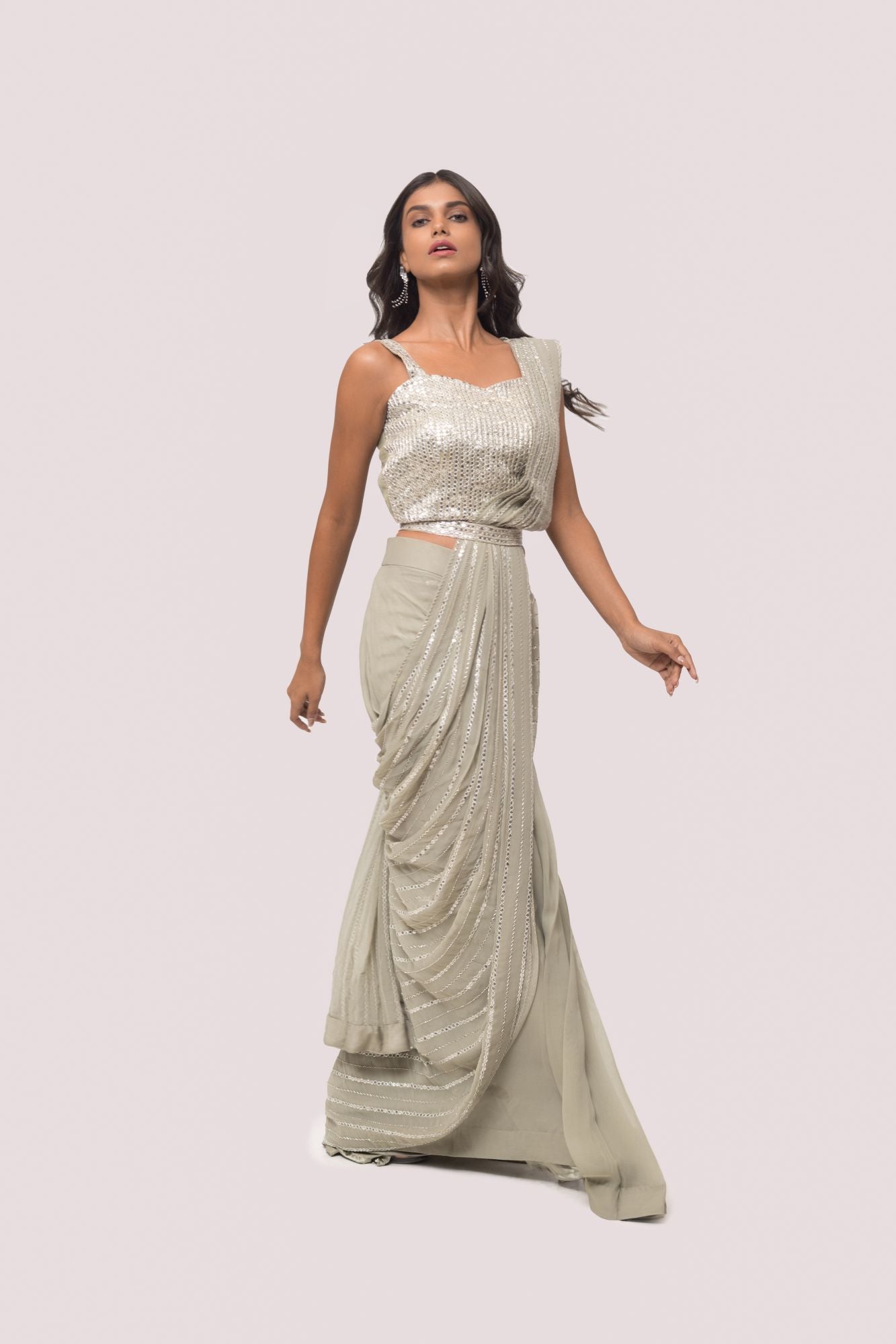Shop the grey mirror work saree with a sleeveless blouse. Make a fashion statement on festive occasions and weddings with designer sarees, designer suits, Indian dresses, Anarkali suits, palazzo suits, designer gowns, sharara suits, and embroidered sarees from Pure Elegance Indian fashion store in the USA.