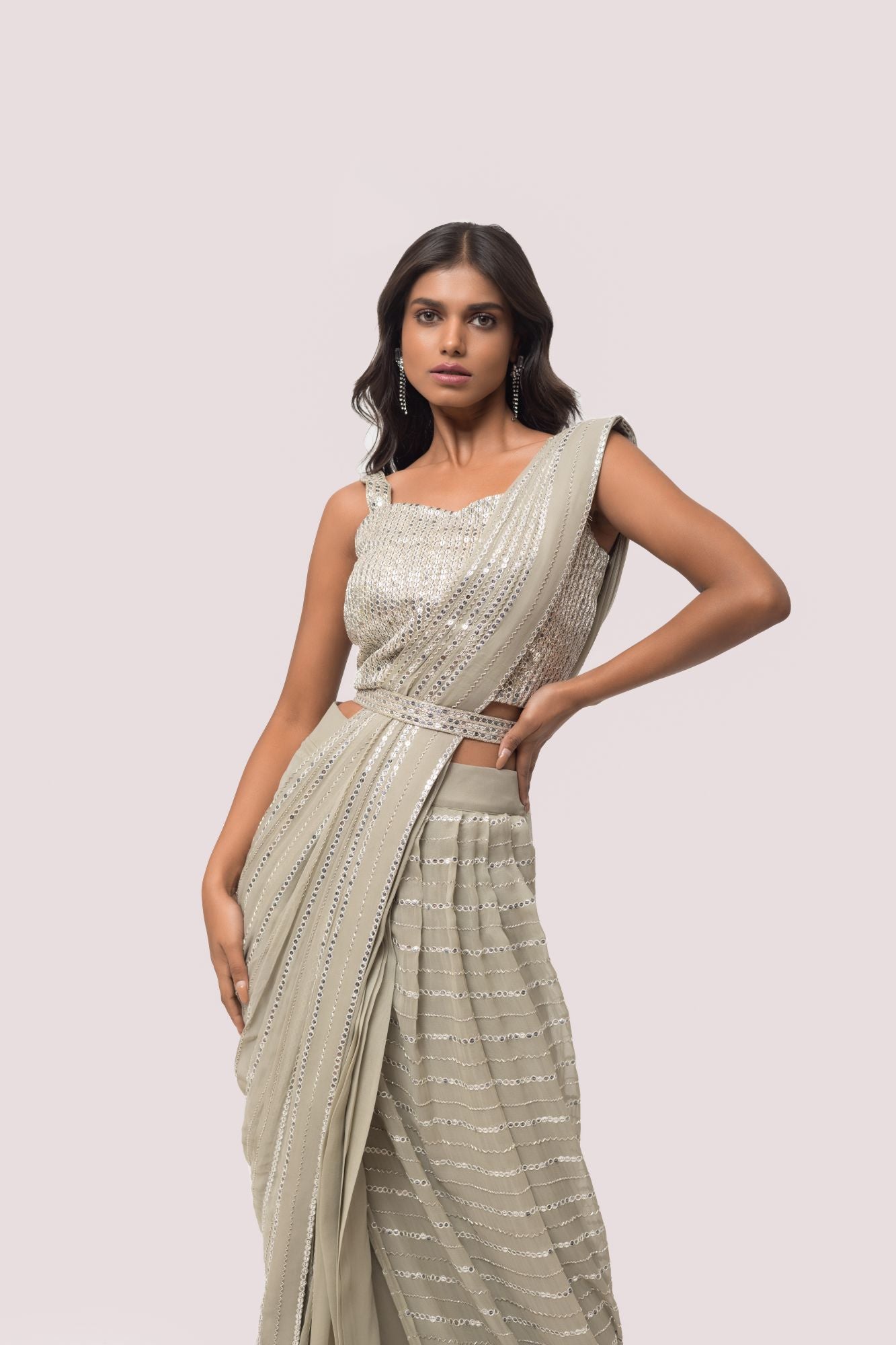Shop the grey mirror work saree with a sleeveless blouse. Make a fashion statement on festive occasions and weddings with designer sarees, designer suits, Indian dresses, Anarkali suits, palazzo suits, designer gowns, sharara suits, and embroidered sarees from Pure Elegance Indian fashion store in the USA.