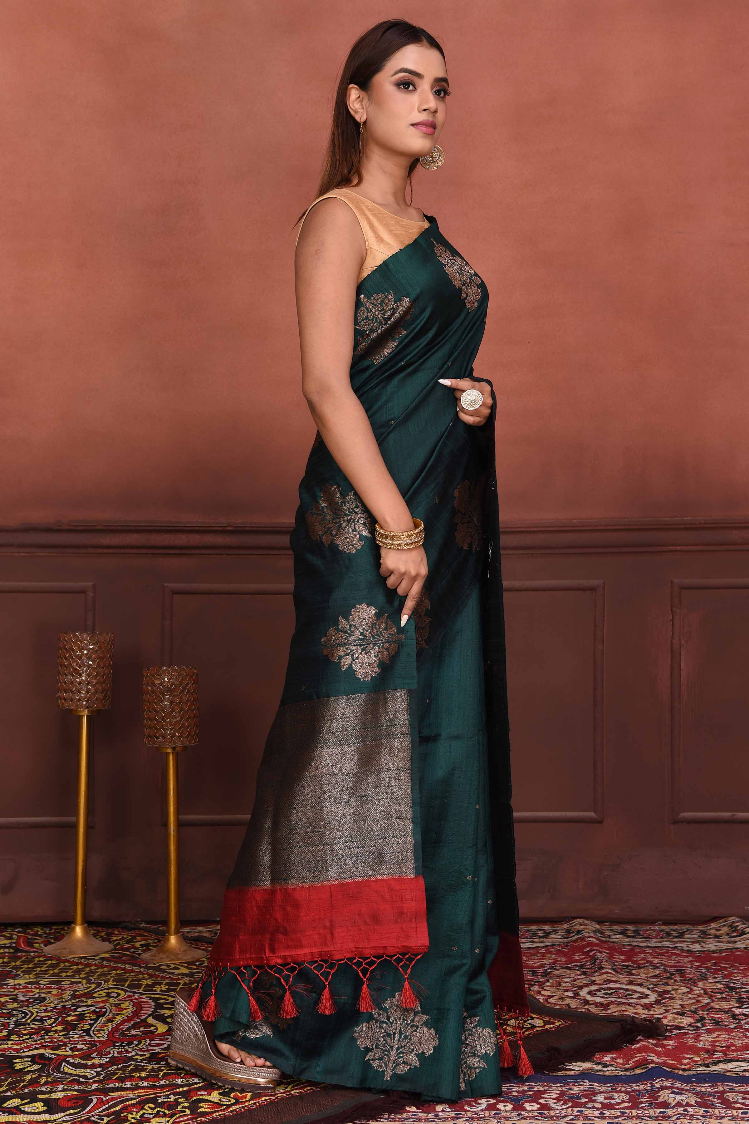 Buy dark green tussar Banarasi saree online in USA with floral zari buta. Look your best on festive occasions in latest designer sarees, pure silk sarees, Kanchipuram silk sarees, handwoven sarees, tussar silk sarees, embroidered sarees from Pure Elegance Indian clothing store in USA.-side