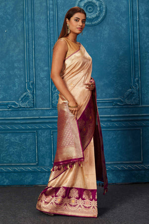 Shop creamish golden Banarasi saree online in USA with purple zari border. Look your best on festive occasions in latest designer sarees, pure silk saris, Kanchipuram silk sarees, handwoven sarees, tussar silk sarees, embroidered sarees from Pure Elegance Indian saree store in USA.-side