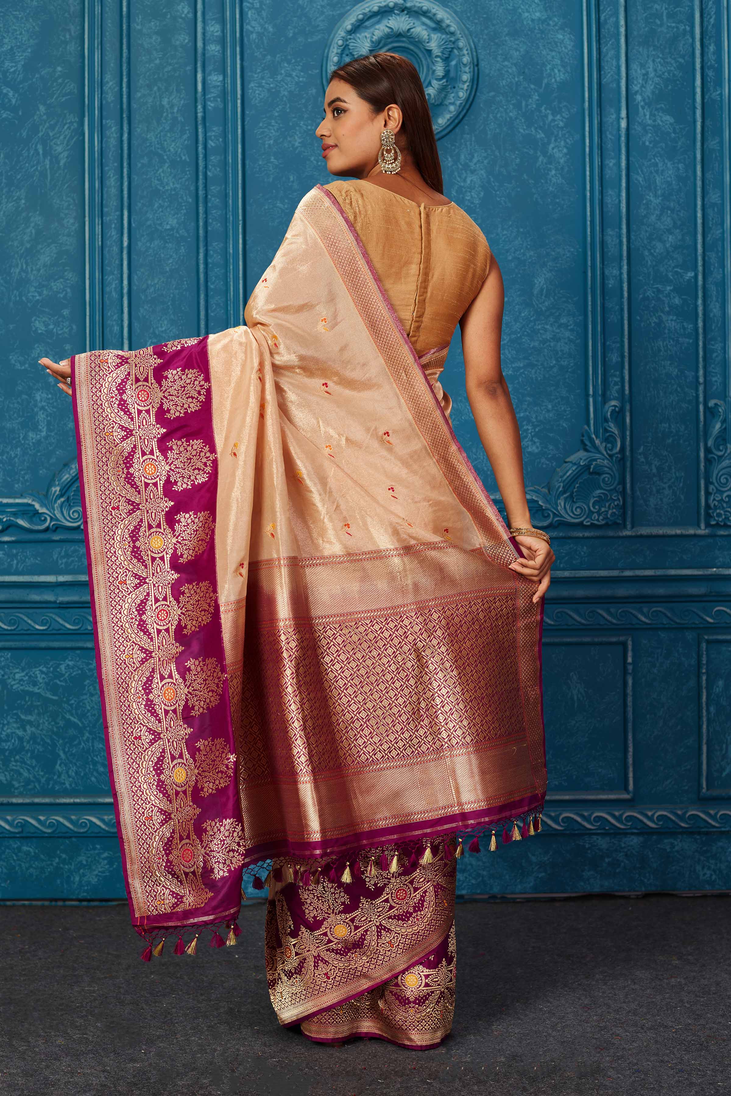 Shop creamish golden Banarasi saree online in USA with purple zari border. Look your best on festive occasions in latest designer sarees, pure silk saris, Kanchipuram silk sarees, handwoven sarees, tussar silk sarees, embroidered sarees from Pure Elegance Indian saree store in USA.-back
