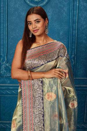 Shop greenish golden Banarasi saree online in USA with blue zari border. Look your best on festive occasions in latest designer sarees, pure silk saris, Kanchipuram silk sarees, handwoven sarees, tussar silk sarees, embroidered sarees from Pure Elegance Indian saree store in USA.-closeup