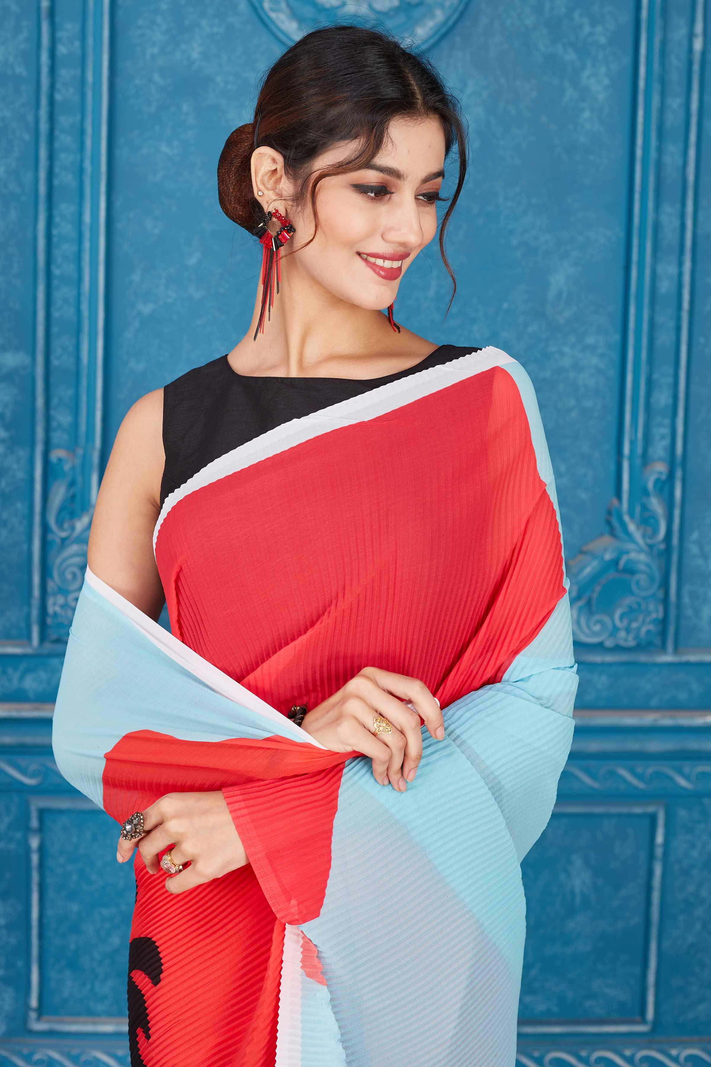 Buy red and powder blue abstract print crushed georgette saree online in USA. Look your best on festive occasions in latest designer sarees, pure silk saris, Kanchipuram silk sarees, handwoven sarees, tussar silk sarees, embroidered saris from Pure Elegance Indian clothing store in USA.-closeup