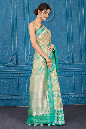 Buy beautiful beige Kora Banarasi sari online in USA with green border. Look your best on festive occasions in latest designer sarees, pure silk saris, Kanchipuram silk sarees, handwoven sarees, tussar silk sarees, embroidered saris from Pure Elegance Indian clothing store in USA.-side