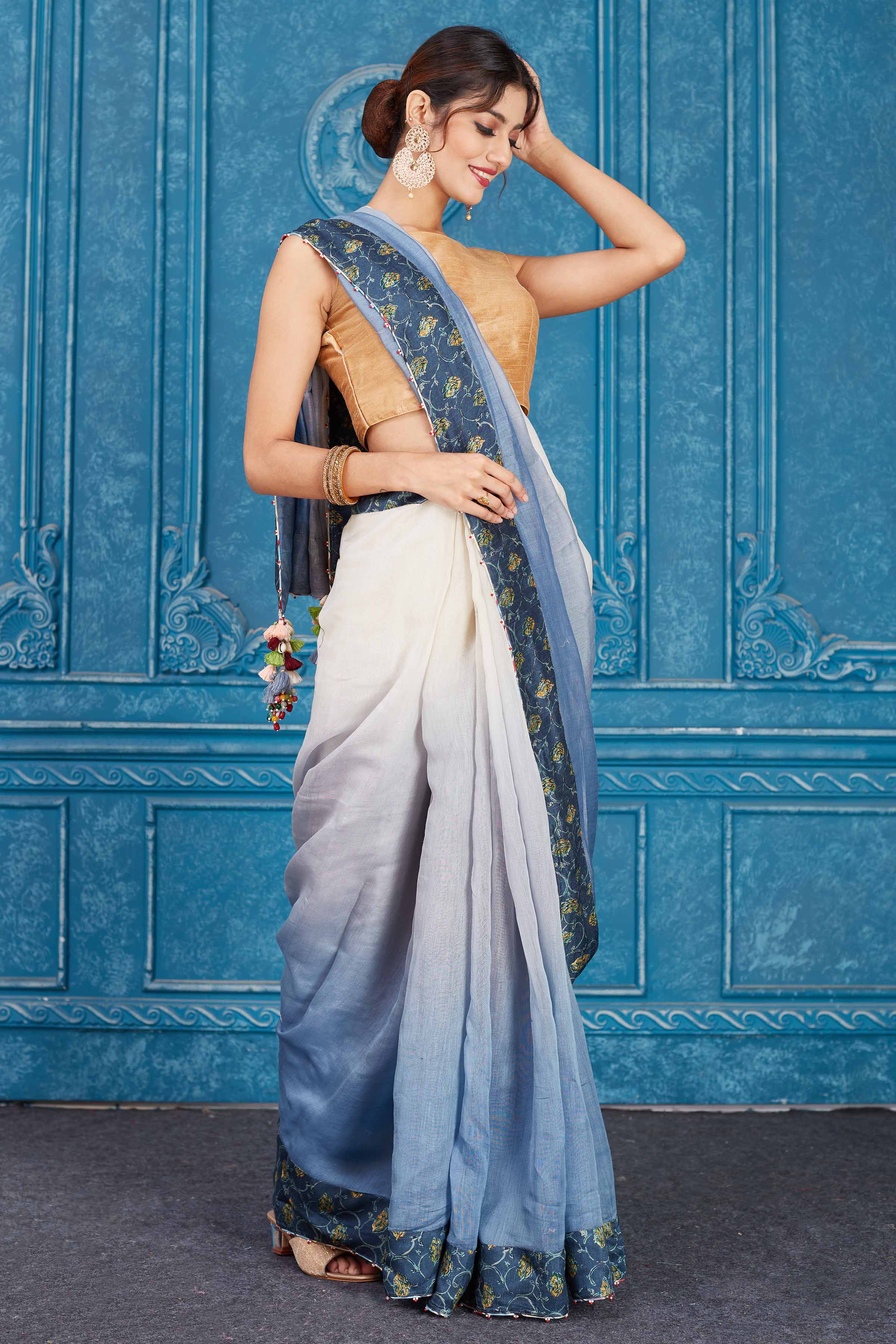 Buy ombre blue linen sari online in USA with floral border. Look your best on festive occasions in latest designer sarees, pure silk saris, Kanchipuram silk sarees, handwoven sarees, tussar silk sarees, embroidered saris from Pure Elegance Indian clothing store in USA.-side