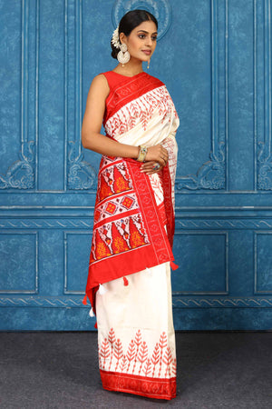 Shop cream pochampally silk ikkat saree online in USA with red border. Look your best on festive occasions in latest designer sarees, pure silk sarees, Kanchipuram sarees, handwoven sarees, tussar silk sarees, embroidered sarees from Pure Elegance Indian clothing store in USA.-side