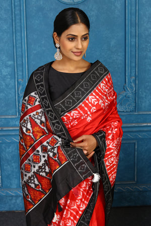 Buy red pochampally silk ikkat saree online in USA with black border. Look your best on festive occasions in latest designer sarees, pure silk sarees, Kanchipuram sarees, handwoven sarees, tussar silk sarees, embroidered sarees from Pure Elegance Indian clothing store in USA.-closeup