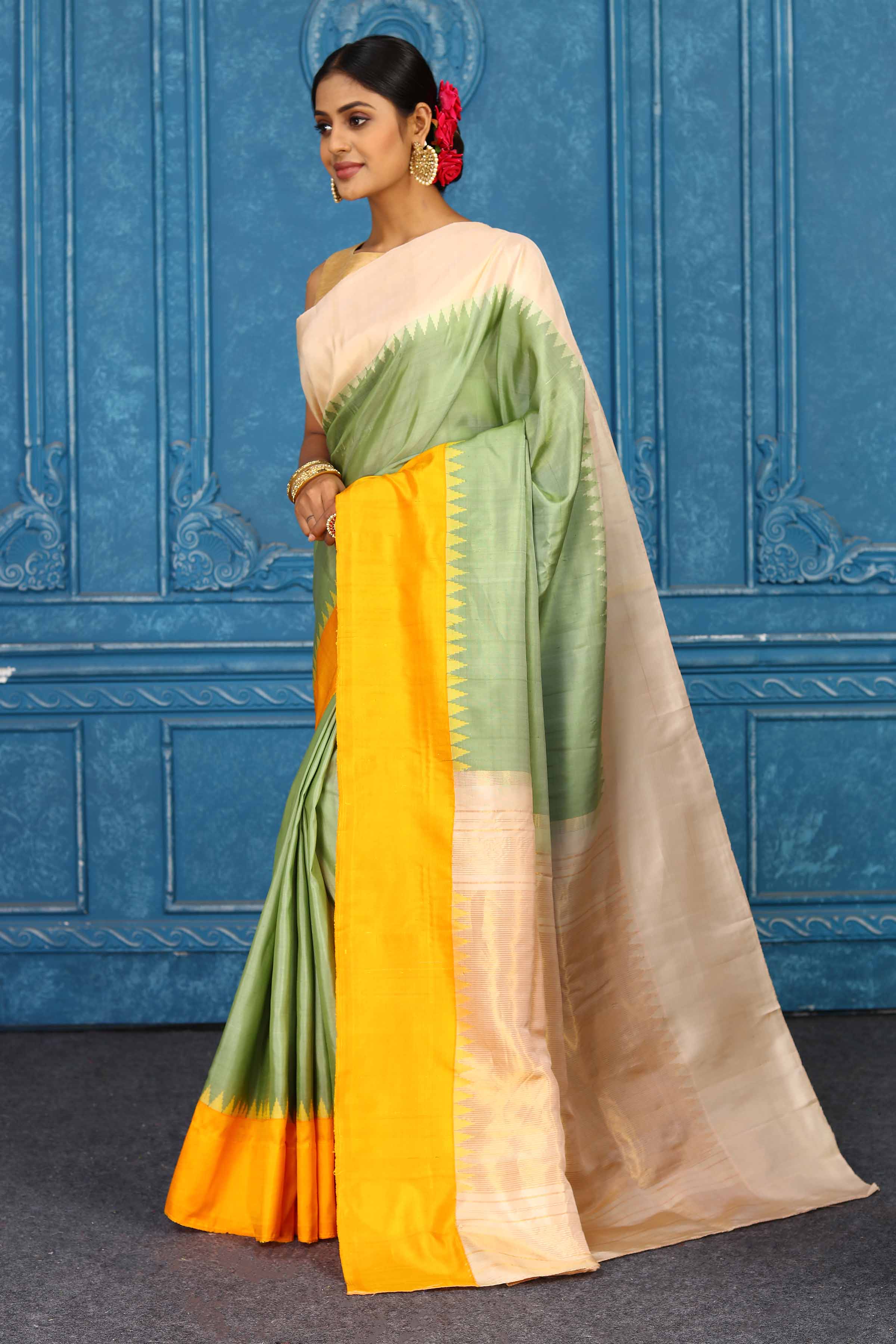 Shop pista green Gadhwal silk saree online in USA with peach yellow border. Level up your ethnic style in latest designer saris, pure silk saris, Kanchipuram silk saris, handwoven sarees, tussar silk sarees, embroidered saris from Pure Elegance Indian clothing store in USA.-pallu