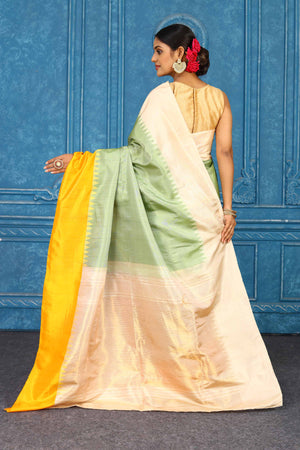 Shop pista green Gadhwal silk saree online in USA with peach yellow border. Level up your ethnic style in latest designer saris, pure silk saris, Kanchipuram silk saris, handwoven sarees, tussar silk sarees, embroidered saris from Pure Elegance Indian clothing store in USA.-back