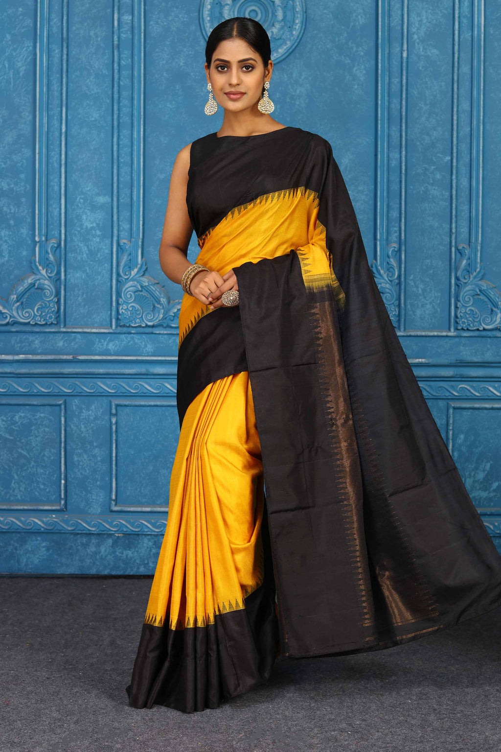 Shop yellow and black Gadhwal silk saree online in USA with zari pallu. Level up your ethnic style in latest designer saris, pure silk saris, Kanchipuram silk saris, handwoven sarees, tussar silk sarees, embroidered saris from Pure Elegance Indian clothing store in USA.- saree