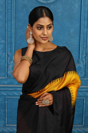 Shop yellow and black Gadhwal silk saree online in USA with zari pallu. Level up your ethnic style in latest designer saris, pure silk saris, Kanchipuram silk saris, handwoven sarees, tussar silk sarees, embroidered saris from Pure Elegance Indian clothing store in USA.-closeup