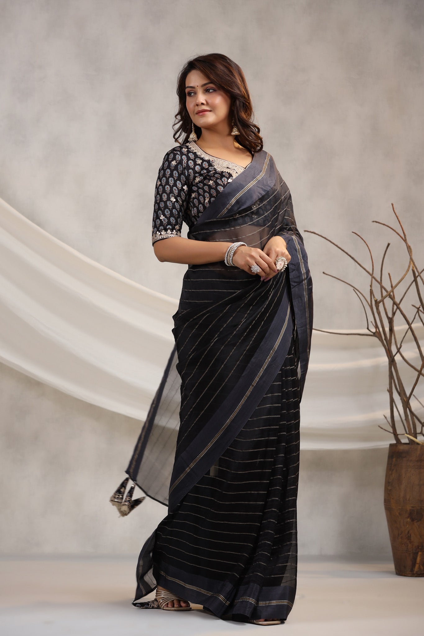 Shop black tissue organza sari online in USA with printed embroidered blouse. Make a fashion statement on festive occasions and weddings with designer suits, Indian dresses, Anarkali suits, palazzo suits, designer sarees, sharara suits, Bollywood saris from Pure Elegance Indian fashion store in USA.-side