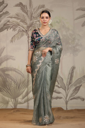 Shop beautiful light grey embroidered organza silk sari online in USA with designer blouse. Make a fashion statement on festive occasions and weddings with designer suits, Indian dresses, Anarkali suits, palazzo suits, designer sarees, sharara suits, Bollywood saris from Pure Elegance Indian fashion store in USA.-front