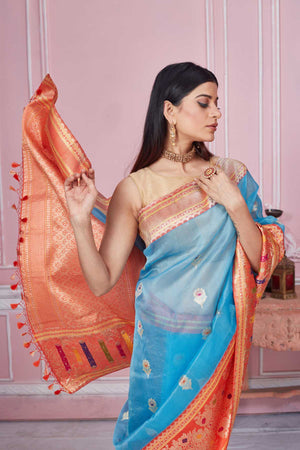 Buy light blue Banarasi sari online in USA with red zari border. Look your best on festive occasions in latest designer saris, pure silk sarees, Kanjivaram silk sarees, handwoven saris, tussar silk sarees, embroidered saris from Pure Elegance Indian fashion store in USA.-closeup
