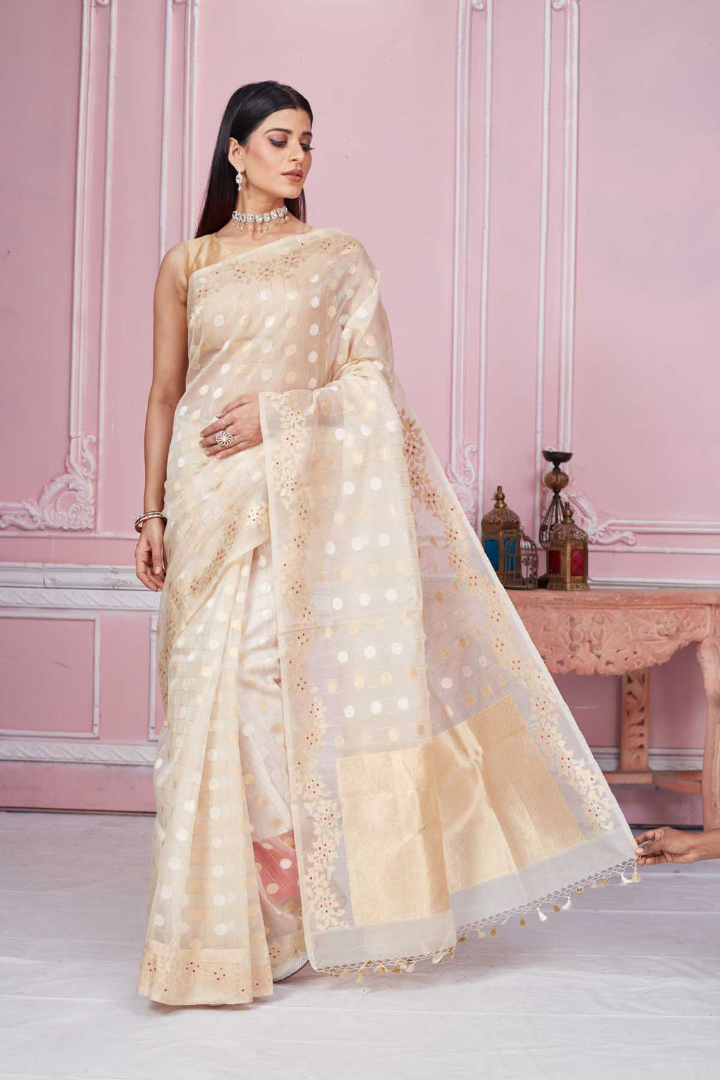 Shop cream Banarasi saree online in USA with scattered buti and zari border. Look your best on festive occasions in latest designer saris, pure silk sarees, Kanjivaram silk sarees, handwoven saris, tussar silk sarees, embroidered saris from Pure Elegance Indian fashion store in USA.-full view
