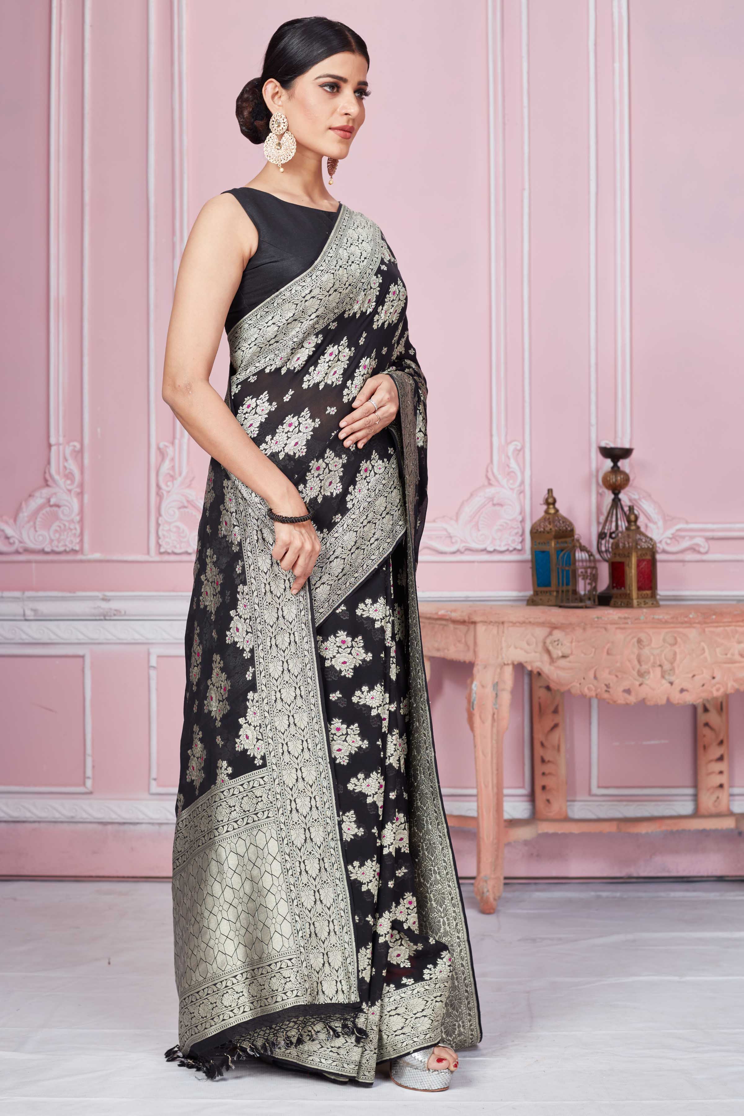 Shop black Banarasi sari online in USA with floral zari minakari motifs. Look your best on festive occasions in latest designer sarees, pure silk saris, Kanchipuram silk sarees, handwoven sarees, tussar silk saris, embroidered sarees from Pure Elegance Indian fashion store in USA.-side
