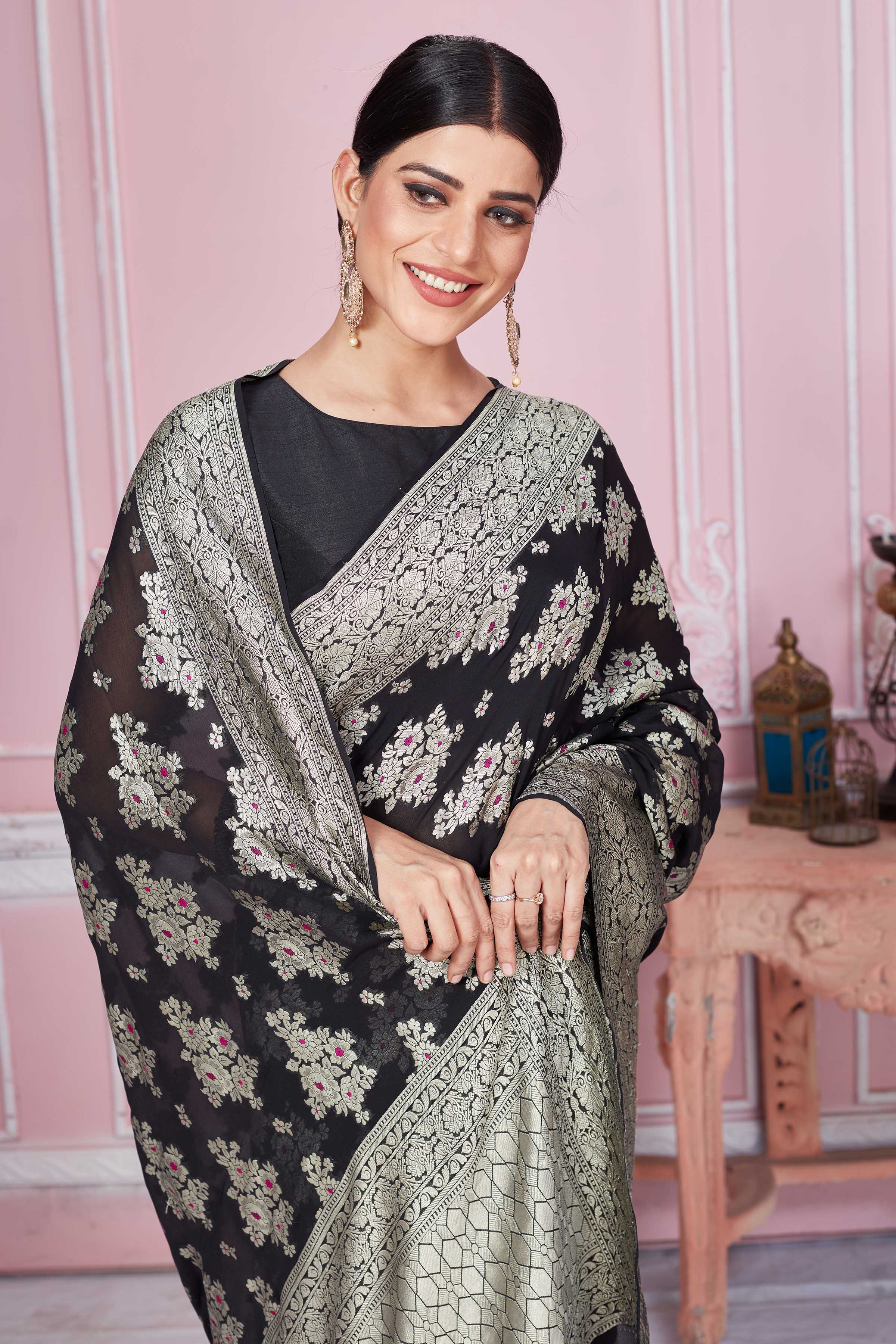 Shop black Banarasi sari online in USA with floral zari minakari motifs. Look your best on festive occasions in latest designer sarees, pure silk saris, Kanchipuram silk sarees, handwoven sarees, tussar silk saris, embroidered sarees from Pure Elegance Indian fashion store in USA.-closeup