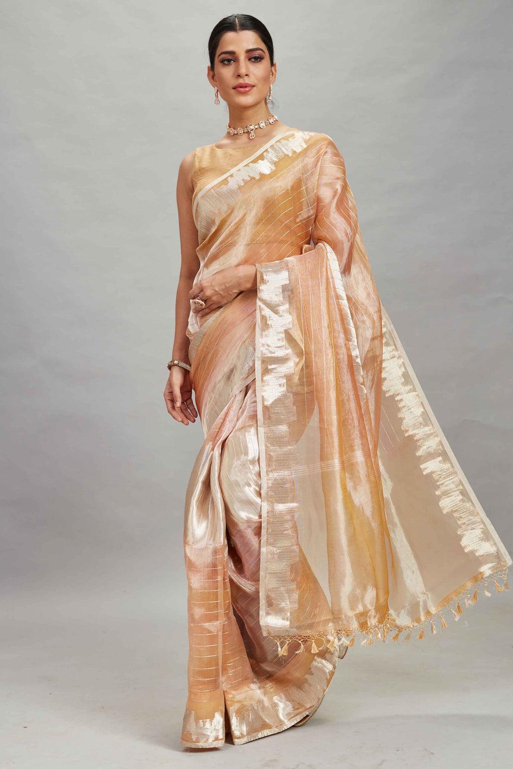 Shop peach and silver striped tissue Banarasi saree online in USA. Look your best on festive occasions in latest designer sarees, pure silk sarees, Kanjivaram silk saris, handwoven saris, tussar silk sarees, embroidered saris from Pure Elegance Indian clothing store in USA.-full view