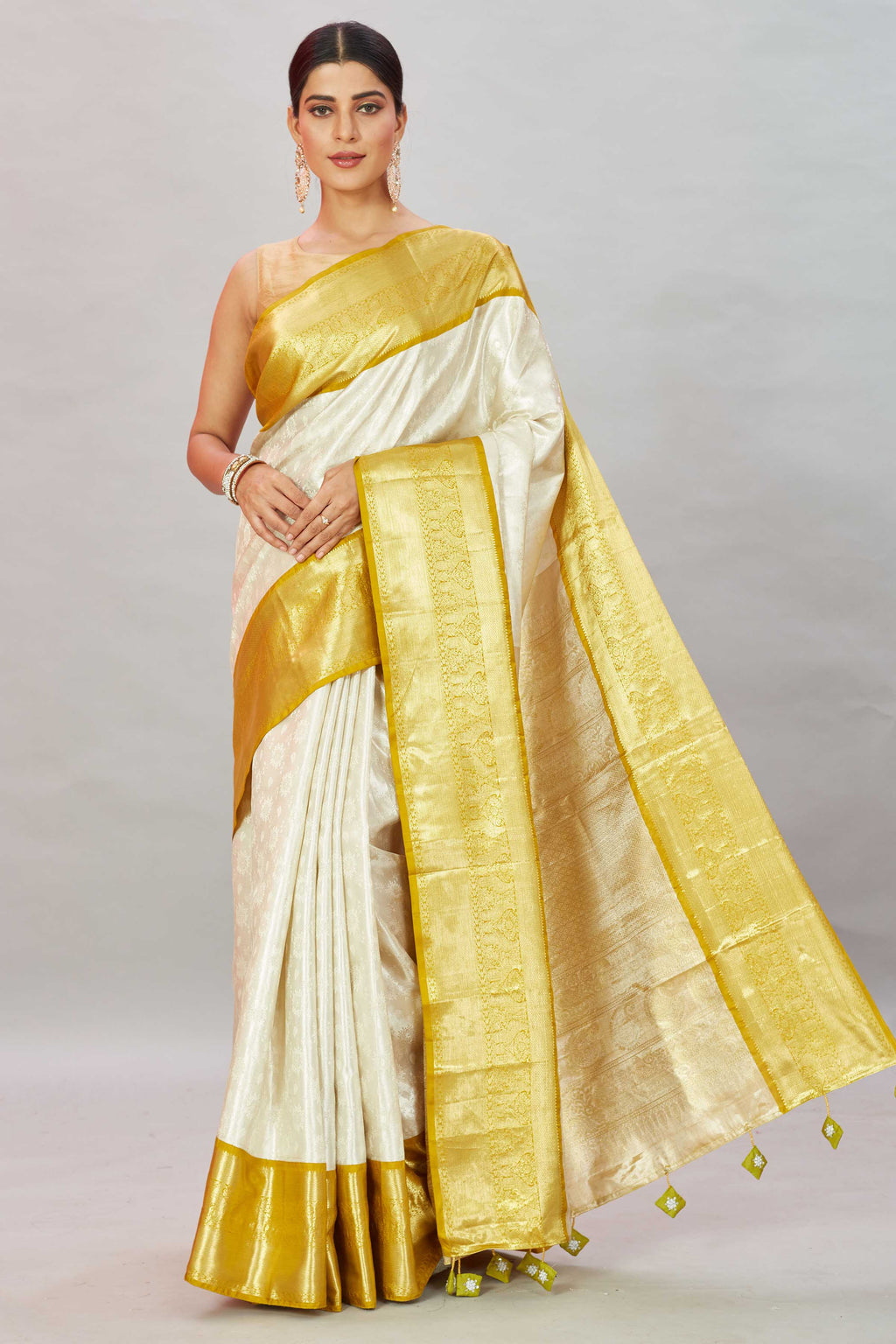 Shop cream Kanjivaram silk sari online in USA with golden zari border. Look your best on festive occasions in latest designer sarees, pure silk sarees, Kanjivaram silk saris, handwoven saris, tussar silk sarees, embroidered saris from Pure Elegance Indian clothing store in USA.-full view