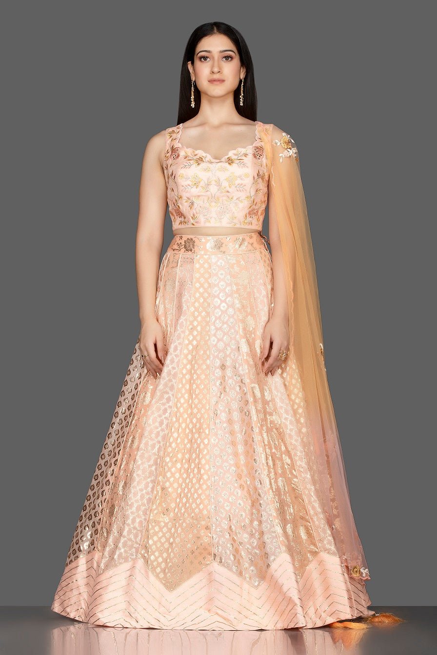 Shop elegant peach embroidered net and silk lehenga online in USA with matching dupatta. Spread ethnic elegance on weddings and special occasions in splendid designer lehengas, Indowestern dresses crafted with exquisite Indian craftsmanship from Pure Elegance Indian fashion store in USA.-full view