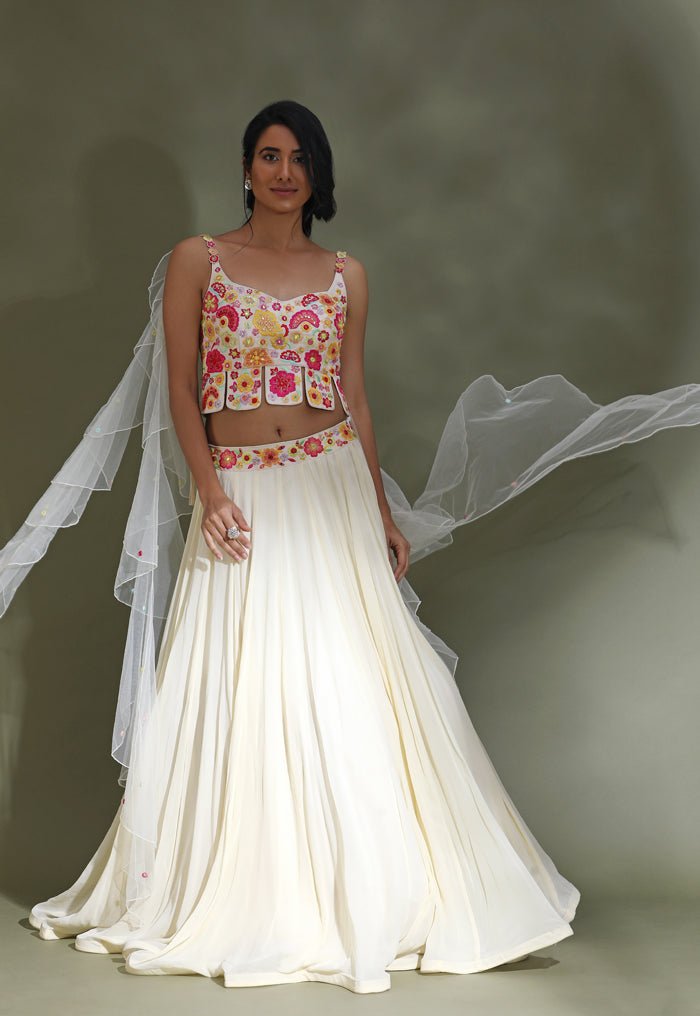 Buy stunning off-white lehenga online in USA with multicolor embroidery blouse. Look your best at weddings and parties in Indian dresses, designer lehengas, Anarkali suits, designer gowns, salwar suits, sharara suits from Pure Elegance Indian fashion store in USA.-front
