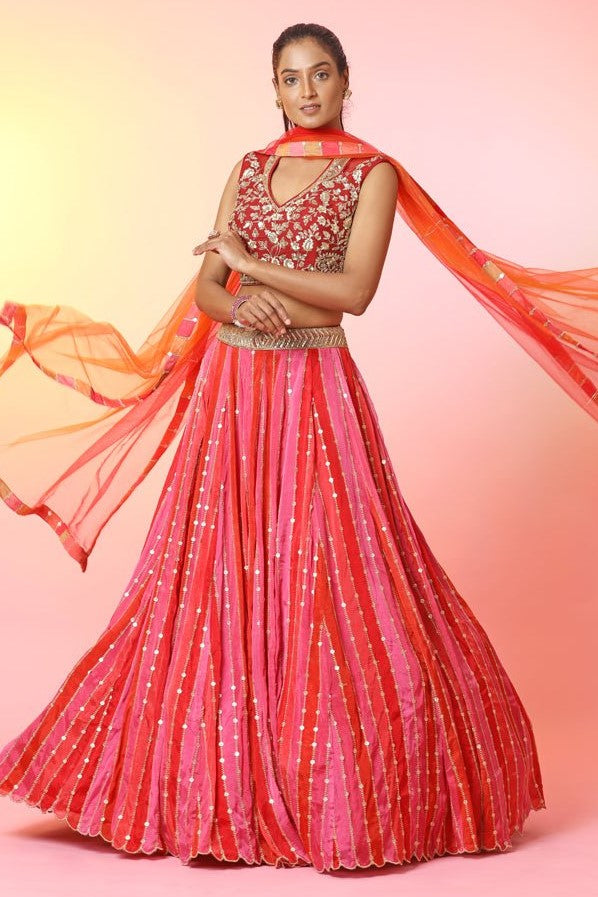 Shop red and pink stripes embroidered lehenga online in USA with dupatta. Look your best at weddings and parties in Indian dresses, designer lehengas, Anarkali suits, designer gowns, salwar suits, sharara suits, embroidered sarees, designer sarees from Pure Elegance Indian fashion store in USA.-front