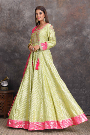 Shop pista green chanderi Banarasi Anarkali online in USA with pink dupatta. Set a style statement on special occasions in exquisite designer lehengas, Anarkali suits, sharara suits, salwar suits, Indowestern outfits from Pure Elegance Indian fashion store in USA.-side
